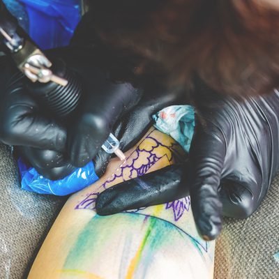 tattoo-artist-inserting-colored-ink-in-human-skin-2024-12-04-14-36-33-utc